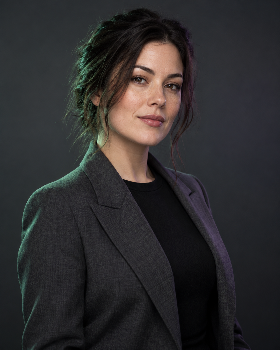 Illustrative studio portrait of a fictional adult wearing a charcoal blazer